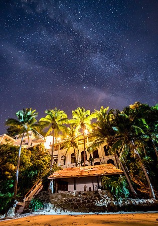 The house from the beach at night.